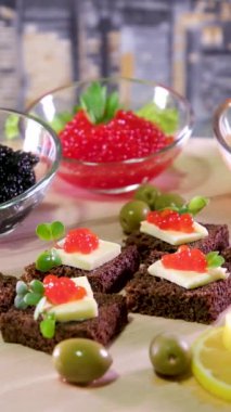 Yemek geçmişi. Kırmızı havyarlı birkaç sandviç bir tabakta döner. Yakın plan. Havyarlı sandviç.