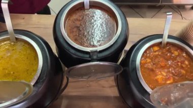 Romen mutfağının farklı türde çömlek çorbaları kepçe kepçesiyle tabaklara saçılmış lezzetli aromatik gıdalar farklı tarifler pişiriliyor yemek odasında geniş bir seçim yapılıyor. Romanya.