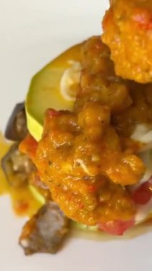 Geleneksel İtalyan caponata, kızarmış ekmeklerle servis edilir, sarı, güneşli bir tencerede. Fesleğen ve çam fıstığı ile süslenmiş. Tabağa kadeh kaldırıyorum. Ratatouille.