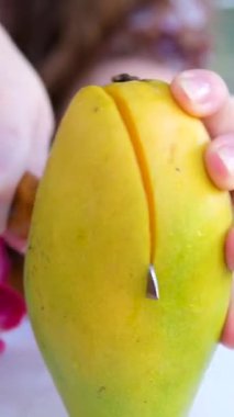 Kız mango kesiyor, lezzetli sulu olgun mango kesiyor bıçakla küp küp kesiyor. Tropik meyve. Mango video eğitiminin nasıl kesileceğini. sağlıklı konsept yemek. Mango Makro kamera hareket ediyor