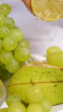 Meyve yememek için üzüm, bal armudu ve peynir tabağı. Üzerine limon suyu serp.