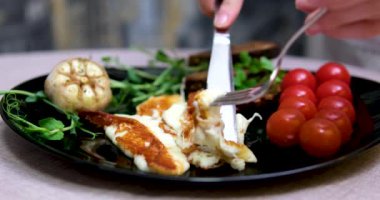Grilled halloumi cheese with herbs. Cooking at home, selective focus