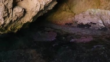 Yunanistan Korfu adası Rocky uçurumu kıyıdaki bir mağarada doğal kaya oluşumları. Yüksek kalite 4k görüntü