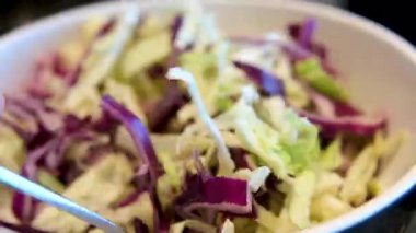 Yemek pişirme ve ev konsepti erkeklerin ellerinin kapalı olduğu bir kasede salata karıştırma. Yüksek kalite 4k görüntü