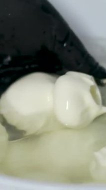Kauçuk eldivenli, tanınmayan kadın fabrika işçilerinin elleri geleneksel peynir yapan mozzarella ve kakovala peynirinin seri üretimini esnetiyor. Yüksek kalite 4k