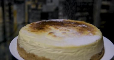 Basque burnt cheesecake on wooden table in baking room. High quality 4k footage