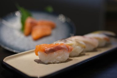 Bambu tahtasındaki Maki suşi ruloları kesme yolu ile beyaz arka planda izole edilmiş. Yüksek kalite fotoğraf