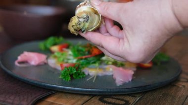 Bullot Salyangozu yemek çubukları sahnesiyle salyangozu çıkarır ve tahta kürdan kullanarak istiridye etini kabuğundan çıkarır. Yüksek kalite 4k görüntü