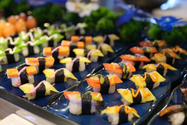 Suşi meraklıları için mükemmel rengarenk ve lezzetli bir seçim sunan çeşitli maki suşi sarmaları. Yüksek kalite 