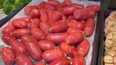 Bir marketteki soğutuculu vitrinde asılı duran taze, el yapımı Longanizalar, kalitelerini ve geleneksel hazırlıklarını vurguluyor. Yüksek kalite 4k görüntü