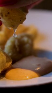 Lezzetli bir sosla servis edilen kızarmış kalamarının tadını çıkarın. Kızarmış kalamar, kremalı sos ve lezzetli bir dilim limonla servis edilir.. 