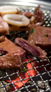 Adam mangalda ahtapot pişirirken dokunaçlarını çeviriyor. Deniz ürünleri dokusu. Yüksek kalite 4k görüntü