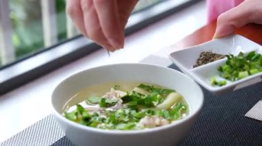 Aşçı çorbanın üzerine erişte ve yumurta serpiyor. Yemeği bitiriyorum. Restorandaki menü. Makarna çorbasına otlar serpin.