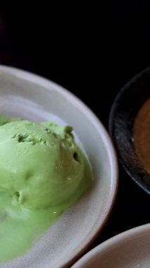 Hassas bir waffle parçasını delip yerken onu çilek şurubuyla dondurmaya batırıyor. Vanilyalı, taze çilekli ve yabanmersinli Belçika waffleları. Merhaba.