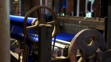 Cinematic video of silkworms hatching, feeding on mulberry leaves, spinning cocoons, and silk threads being reeled and woven into traditional Vietnamese textiles.