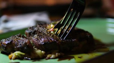 Yakından ve yukarıdan bakınca ızgara bifteğin çatal ve bıçakla dilimlendiği taze et, patates püresi ve taze salata. Lezzetli detaylarla yakalanmış mükemmel bir gurme yemeği..