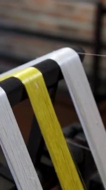 Cinematic video of silkworms hatching, feeding on mulberry leaves, spinning cocoons, and silk threads being reeled and woven into traditional Vietnamese textiles.