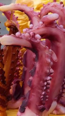 Ahtapot dokunaçları yemek için hazırdır. Deniz ürünleri yeşil marul yaprakları üzerinde yemek için hazır. Yüksek kalite 4k görüntü