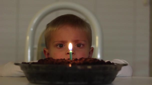 Boy Blowing Out Candle Chocolate Ice Cream Pie — Stock Video