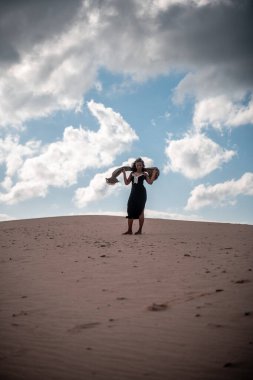 African girl with headscarf in the desert.