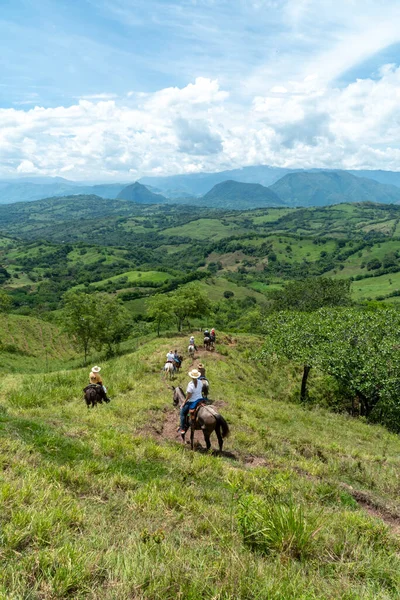 stock image Tamesis, Antioquia, Colombia. June 29, 2020: Horseback riding in the field with beautiful blue sky.