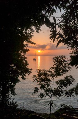 Günbatımı ve doğal yaprak çerçeveli tekne. Fuerte Adası. Kolombiya