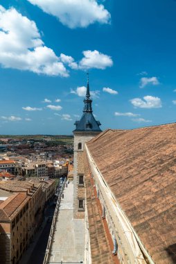 Toledo, Spain. April 29, 2022: Toledo Cathedral with blue sky and panoramic city landscape.