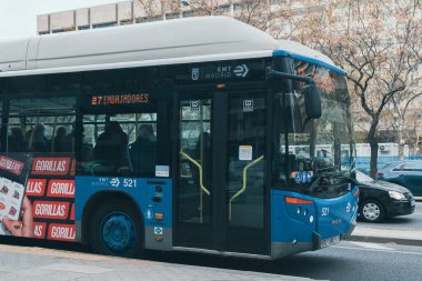 Madrid, Spain. April 5, 2022: Blue buses and means of transport in the city with blue sky.