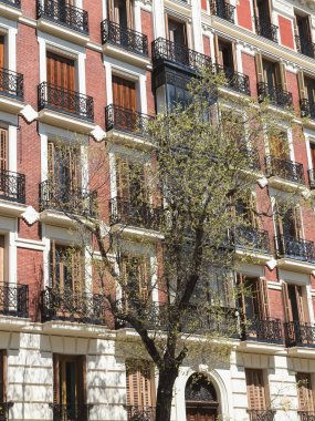 Madrid, Spain. April 6, 2022: architecture and facade of houses with beautiful blue sky.
