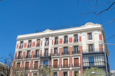 Madrid, Spain. April 6, 2022: architecture and facade of houses with beautiful blue sky.