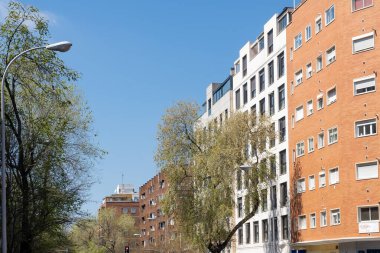 Madrid, Spain. April 6, 2022: architecture and facade of houses with beautiful blue sky.