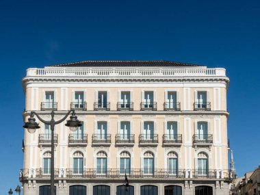 Madrid, Spain. April 6, 2022: architecture and facade of houses with beautiful blue sky.