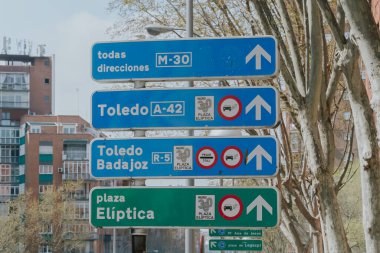 Madrid, Spain. April 6, 2022: City traffic signals. Traffic lights and signage.