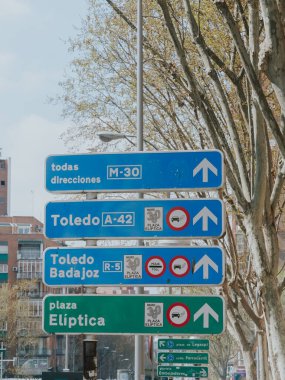 Madrid, Spain. April 6, 2022: City traffic signals. Traffic lights and signage.