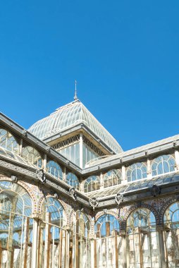 Madrid, Spain. April 6, 2022: Crystal palace facade and architecture with blue sky.