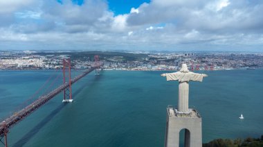 Lisbon, Portugal. April 11, 2022: Panoramic landscape with a view of the Tagus river and 25 de Abril bridge.