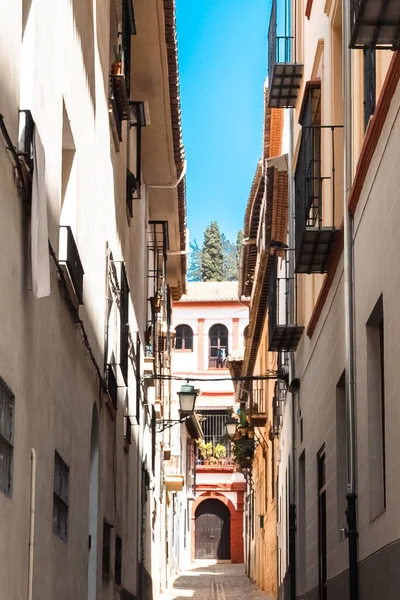 stock image Granada,Spain. April 14, 2022: Architecture of the center of Granada on a summer day and blue sky.