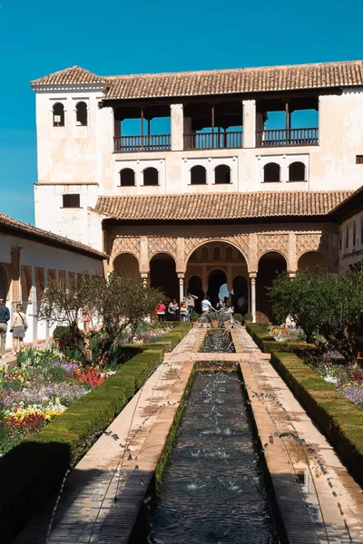 stock image Granada,Spain. April 17, 2022: Architecture and facade of the Generalife Palace with beautiful blue sky.