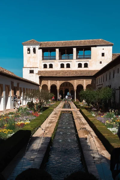 stock image Granada,Spain. April 17, 2022: Architecture and facade of the Generalife Palace with beautiful blue sky.