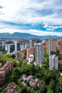 Medellin, Antioquia, Kolombiya. 3 Mayıs 2023: Şehirdeki binalar ve mavi gökyüzüyle manzara.