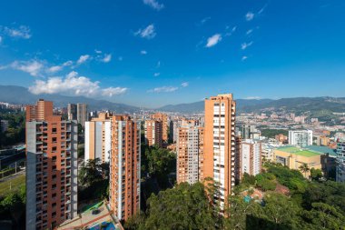 Medellin, Antioquia, Kolombiya. 3 Mayıs 2023: Şehirdeki binalar ve mavi gökyüzüyle manzara.