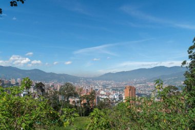 Medellin, Antioquia, Kolombiya. 18 Temmuz 2020: Dağları ve mavi gökyüzüyle Medellin şehrinin panoramik ve kentsel manzarası.