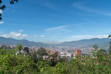 Medellin, Antioquia, Kolombiya. 18 Temmuz 2020: Dağları ve mavi gökyüzüyle Medellin şehrinin panoramik ve kentsel manzarası