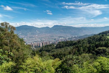 Medellin, Antioquia, Kolombiya. 18 Temmuz 2020: Dağları ve mavi gökyüzüyle Medellin şehrinin panoramik ve kentsel manzarası