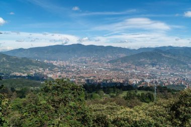 Medellin, Antioquia, Kolombiya. 18 Temmuz 2020: Dağları ve mavi gökyüzüyle Medellin şehrinin panoramik ve kentsel manzarası
