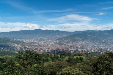 Medellin, Antioquia, Kolombiya. 18 Temmuz 2020: Dağları ve mavi gökyüzüyle Medellin şehrinin panoramik ve kentsel manzarası