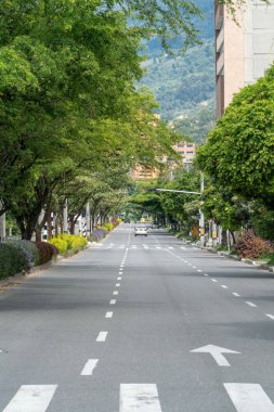 Medellin, Antioquia, Colombia. July 20, 2020: 33rd Avenue. Cityscape of avenue and mountains with sky.