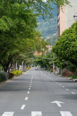 Medellin, Antioquia, Colombia. July 20, 2020: 33rd Avenue. Cityscape of avenue and mountains with sky.