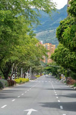 Medellin, Antioquia, Colombia. July 20, 2020: 33rd Avenue. Cityscape of avenue and mountains with sky.