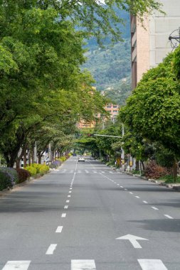 Medellin, Antioquia, Colombia. July 20, 2020: 33rd Avenue. Cityscape of avenue and mountains with sky.